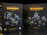 The image features two box sets from Steamforged Games for the Cygnar faction in the Warmachine tabletop game. On the left, the "Cygnar Gravediggers Battlegroup Box Set" showcases a warcaster and two warjacks, with vibrant blue and metallic details on the miniatures. On the right, the "Cygnar Gravediggers Command Starter" includes a more diverse array of models, featuring a heavy warjack, a three-model unit, and a character solo, all set against a dark background that highlights the colorful packaging and intricate designs.