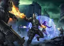 A futuristic soldier in armored suit with glowing blue energy shield, firing orange flames from hands, standing on a ruined cityscape with debris. Two other figures in tactical gear and one shadowy figure in the background.