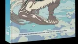 Book cover for "Obojima: Tales from the Tall Grass." A large, light gray skeletal fish head with sharp teeth and an open mouth dominates the lower half of the cover. A young girl with red hair, wearing a pink dress, stands on the fish's upper jaw, looking towards the right. The background is a bright blue sky with fluffy white clouds. The title "OBOJIMA" is prominently displayed in white text at the top, with the subtitle "Tales from the Tall Grass" in smaller white text below it. Additional text in a different script appears next to the subtitle. The spine of the book on the left side also displays the title "OBOJIMA" vertically in white text.