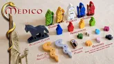 Wooden game pieces: barbers, medicus, apprentices, knowledge marker, remedies, coins, and an owl.