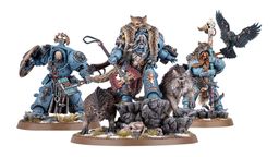 A detailed display features a group of new Space Wolves miniatures, prominently showcasing Logan Grimnar in ornate terminator armor, adorned with a fur cloak and wielding his axe, Morkai. He is flanked by two wolves, Tyrnak and Fenrir, and accompanied by his lieutenants, Arjac Rockfist and Njal Stormcaller, who are also intricately designed. The scene is set on rocky terrain with scattered skulls and grass, enhancing the fierce and wild aesthetic of the Space Wolves.