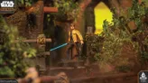 A detailed miniature of Luke Skywalker stands on a rocky terrain, holding a blue lightsaber in one hand and a blaster in the other. He is dressed in a yellow jacket with black accents, and the background features lush greenery and wooden structures, creating a vibrant and dynamic scene. The image captures the essence of the Star Wars universe, highlighting the character's iconic look and the adventurous setting.