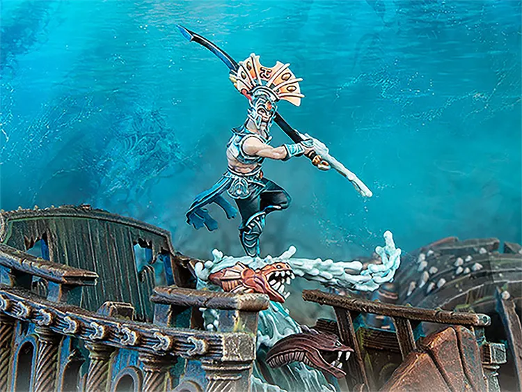 A dynamic scene features an Idoneth Deepkin warrior, the Ikon of the Sea, poised on a wave of water, wielding a curved sword and adorned with intricate armor and a decorative headdress. In the background, remnants of a shipwreck are visible, with splashes of water and a menacing sea creature emerging from the waves. The overall color palette includes vibrant blues and earthy tones, enhancing the aquatic theme of the model.