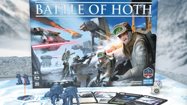 The image features the box art for "Star Wars: Battle of Hoth," showcasing a snowy battlefield scene with Rebel soldiers in action, equipped with blasters and wearing winter gear. In the foreground, two AT-AT walkers are positioned alongside game components, including cards and dice, set on a hexagonal game board. The title "BATTLE OF HOTH" is prominently displayed at the top, with branding from Asmodee and Days of Wonder visible in the corners.