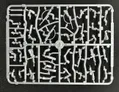 A plastic sprue featuring various components for miniature figures, including torsos, limbs, and heads, designed for 28mm scale modern civilians and post-apocalyptic survivors. The sprue showcases a variety of poses and accessories, including weapons, allowing for customization of the miniatures. The pieces are molded in a light gray plastic and are arranged in a grid pattern on a black background.