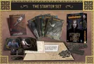 A boxed set labeled "Interview with the Vampire Starter Set" from Immortal Universe RPG, featuring a dark-haired man’s portrait. Surrounding it are four cards titled "A Scent of Cloves and Lilac", a handwritten note, and scattered circular tokens with symbols like "Hunt 60" and "French Quarter."