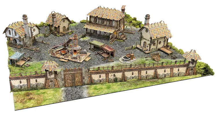 A detailed tabletop terrain scene depicting the Ingonsburn Township, featuring a cobblestone market square surrounded by various buildings, including a large inn, a foundry, and cottages, all enclosed by a secure boundary wall. The buildings have textured roofs and are adorned with furniture, while a central well or forge adds to the bustling atmosphere. Lush green grass peeks through the cobblestones, enhancing the vibrant fantasy setting.