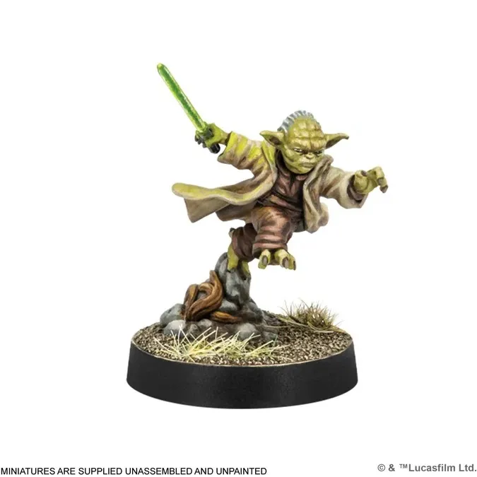 Yoda miniature holding a green lightsaber on a rocky base