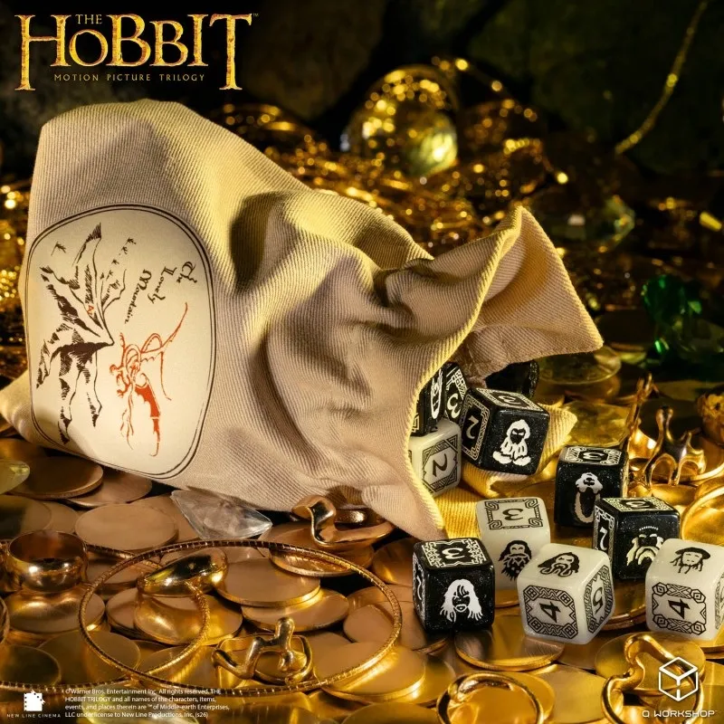 A beige drawstring bag with a dragon emblem, gold coins, and black and white dice with Middle-earth symbols.