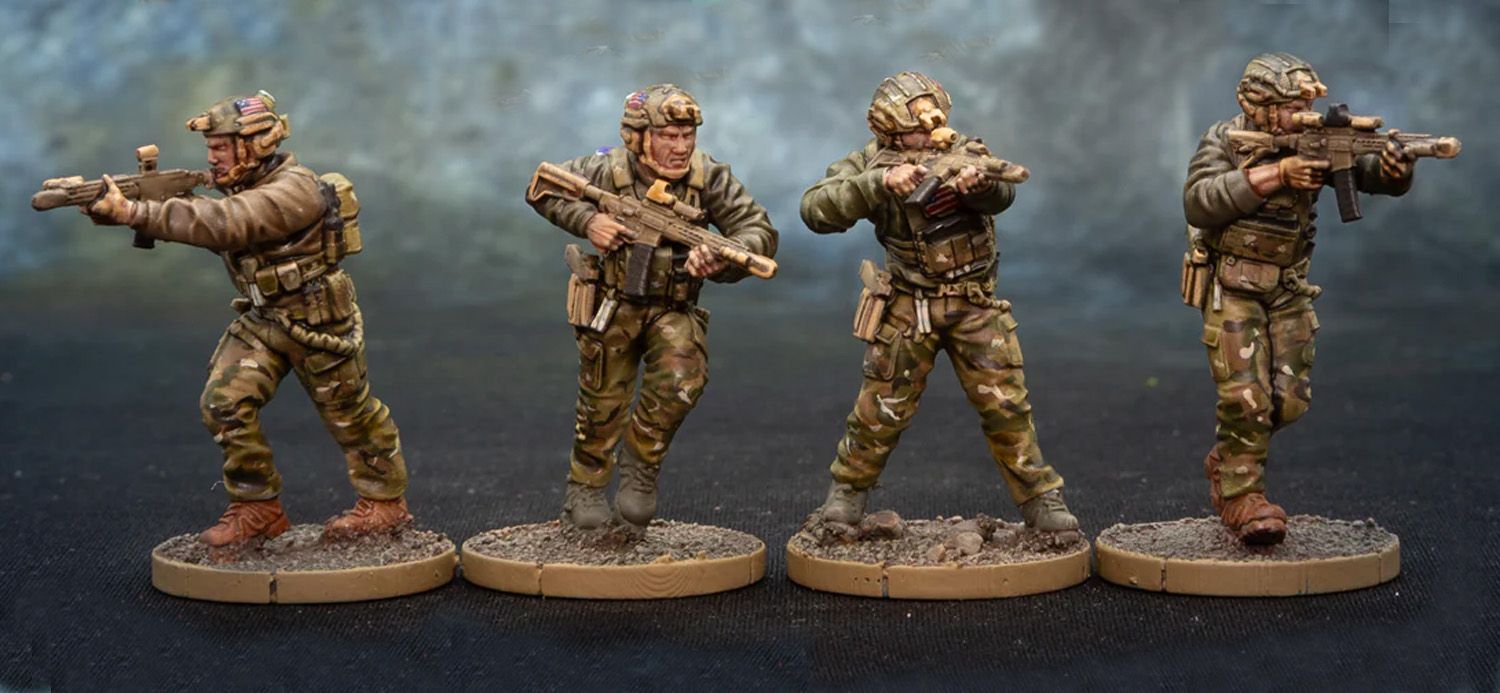 Three detailed miniature figures of soldiers are displayed, each standing on a circular base with a textured surface resembling dirt. The figures are dressed in tactical gear with camouflage patterns, holding various firearms. The soldier on the left is aiming a rifle, the central figure is preparing to fire, and the soldier on the right is also holding a weapon, showcasing a variety of poses and expressions that convey action and readiness.