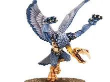 Miniature of a Greater Daemon of Tzeentch with blue-grey skin, golden wings, and ornate armor. Standing on a round base, holding a staff in one hand and a skull-like head in the other. Text in top right corner reads "Warhammer Community."