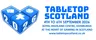 A blue graphic featuring two large dice, one showing the number 26, alongside the text "TABLETOP SCOTLAND" in bold blue letters. Below, the event details are listed: "4TH TO 6TH SEPTEMBER 2026, ROYAL HIGHLAND CENTRE, EDINBURGH, AT THE HEART OF GAMING IN SCOTLAND," along with the website address "www.tabletopscotland.co.uk." The overall design emphasizes the tabletop gaming theme with a clean and engaging layout.