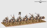 Nine skeleton warriors on horseback, armed with swords and shields, riding in a line on a battlefield terrain. One figure at the front holds a large banner with a blue and gold design. Text at top right reads "Warhammer Community."