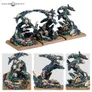 Miniature terrain piece featuring three skeletal creatures emerging from a dark, rocky base. Each figure has elongated limbs, exposed bones, and tattered cloth. The base includes textured rockwork with embedded skulls and debris. Four views show different angles of the structure.