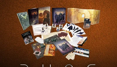 A collection of items from the Dune RPG Physical Megabundle is displayed against a textured brown background. The assortment includes various books, game components, and promotional materials, prominently featuring the Dune logo and the text "Supporting: ACLU." The items are arranged in a visually appealing manner, showcasing the core rulebook, adventure modules, and other game accessories.