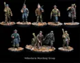 A collection of detailed miniatures representing a Volksturm marching group, showcasing various figures in WWII-era attire. The miniatures are painted in muted colors, with some wearing overcoats and others in military uniforms, each holding weapons or equipment. They stand on scenic bases featuring rubble and debris, enhancing the historical context of the scene.