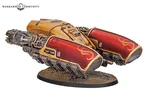 Golden and red armored vehicle with mechanical details on a rocky base.