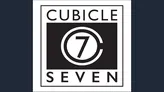 The image features the logo of Cubicle 7, a tabletop role-playing game publisher. The design is a square with a black background, prominently displaying the words "CUBICLE" at the top and "SEVEN" at the bottom in white capital letters. In the center, there is a circular emblem with the number "7" in a bold, stylized font, surrounded by a thin white ring. The overall aesthetic is clean and modern, emphasizing the brand's identity in the gaming community.