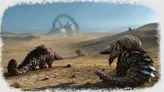 Desert with large metallic structure in background, colorful scaled creatures in foreground