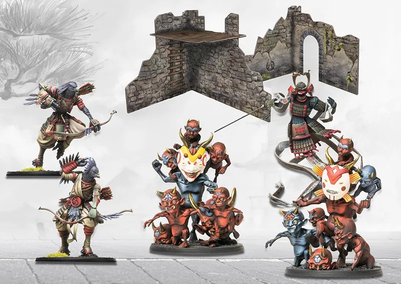 Miniature figures of warriors and demons around a stone castle ruin.