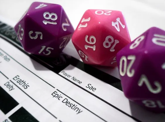 Photo of 3 d20 dice and part of a character sheet