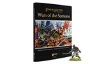 The image features the cover of the "Wars of the Samurai" supplement for the Pike & Shotte tabletop game, prominently displaying a vibrant illustration of a 15th and 16th-century Japanese battle scene, complete with samurai warriors in traditional armor wielding weapons and banners. To the right, there is a detailed miniature of Yasuke, the Black Samurai, depicted in a dynamic pose, dressed in colorful armor and holding a sword. The book's title is elegantly printed in gold lettering at the top, with the Warlord Games logo at the bottom.