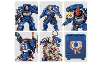 A collection of Ultramarine miniatures showcases various Space Marine figures in blue armor, each featuring distinct details and accessories. The top row includes a character with a prominent helmet and ornate chest emblem, alongside two other figures with different poses and weaponry. The bottom row features a close-up of a figure holding a weapon, another with a skull motif on the armor, and a character wielding a large, intricately designed shield. Additionally, a transfer sheet with various decals is visible, featuring Ultramarine symbols and decorative borders.