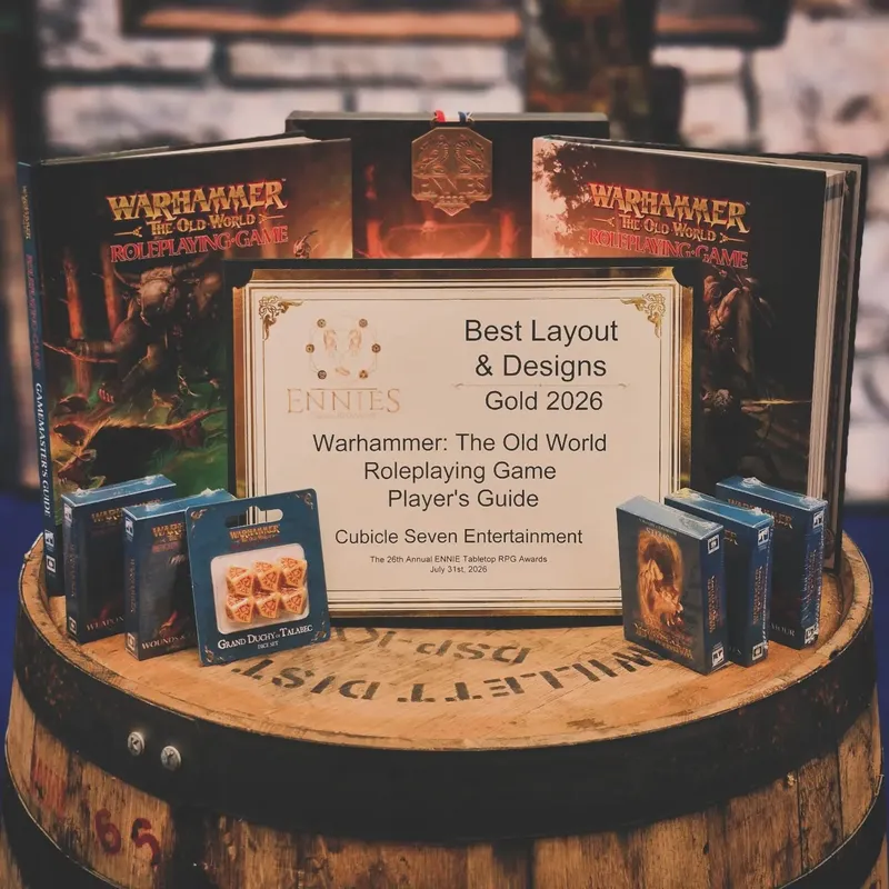 Award plaque on barrel with Warhammer books, dice, and boxes.