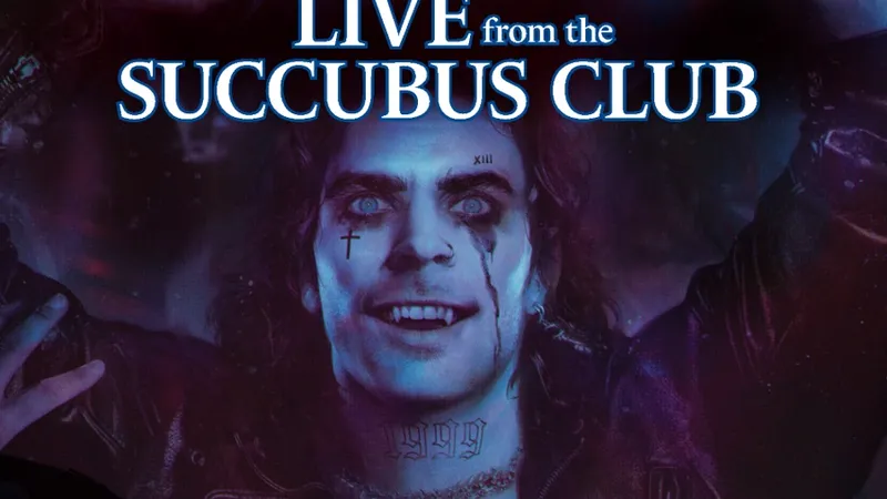 A vampire with pale skin and striking blue eyes is depicted in a dark, atmospheric setting, wearing a leather jacket and showcasing numerous tattoos across his chest and neck. His expression is exuberant, with a wide smile and streaks of dark makeup running down his face, suggesting a rock star persona. The background features a blend of purple and blue hues, enhancing the club-like ambiance, while the title "LIVE from the SUCCUBUS CLUB" is prominently displayed at the top.