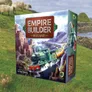 Boxed board game titled "Empire Builder: Ireland" with a green train traveling through a scenic Irish landscape, including cliffs, waterfall, and sheep grazing on grass. Text reads "Designed by M. Robert Stribula."