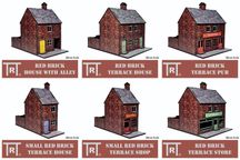 A collection of six 28mm scale MDF buildings is displayed, featuring a red brick design. The buildings include a "Red Brick House with Alley," "Red Brick Terrace House," "Red Brick Terrace Pub," "Small Red Brick Terrace House," "Small Red Brick Terrace Shop," and "Red Brick Terrace Store." Each building showcases distinct features, such as varying door colors and signage options, suitable for various historical genres.