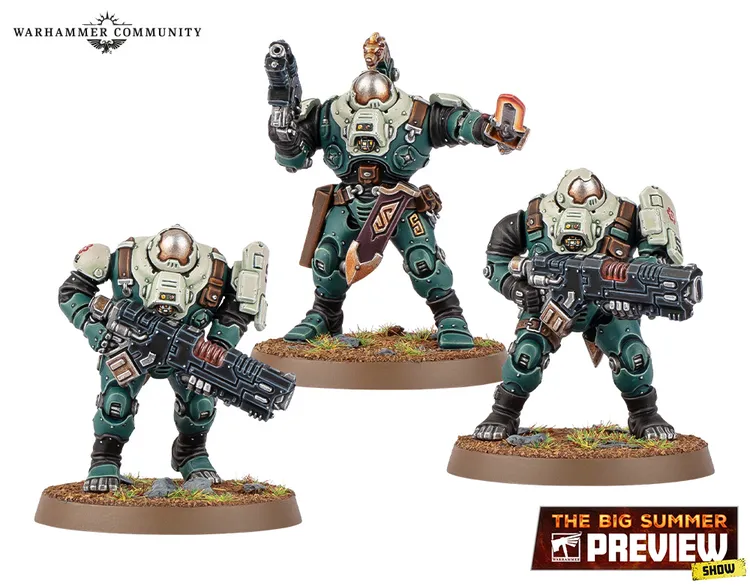 Three miniature figures from the Leagues of Votann are displayed on a grassy base. The central figure, slightly taller, is equipped with a pistol and has a distinctive armor design featuring green and beige colors, along with a decorative belt. The two flanking figures are shorter, one holding a large futuristic weapon, while the other has a more relaxed stance with a hand raised, possibly gesturing. All three figures exhibit a robust, armored appearance typical of the faction's aesthetic.