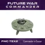 A green flying saucer model with a seated figure inside, labeled "FWC-TEX2 Commander in Saucer." Background text reads "Future War Commander."