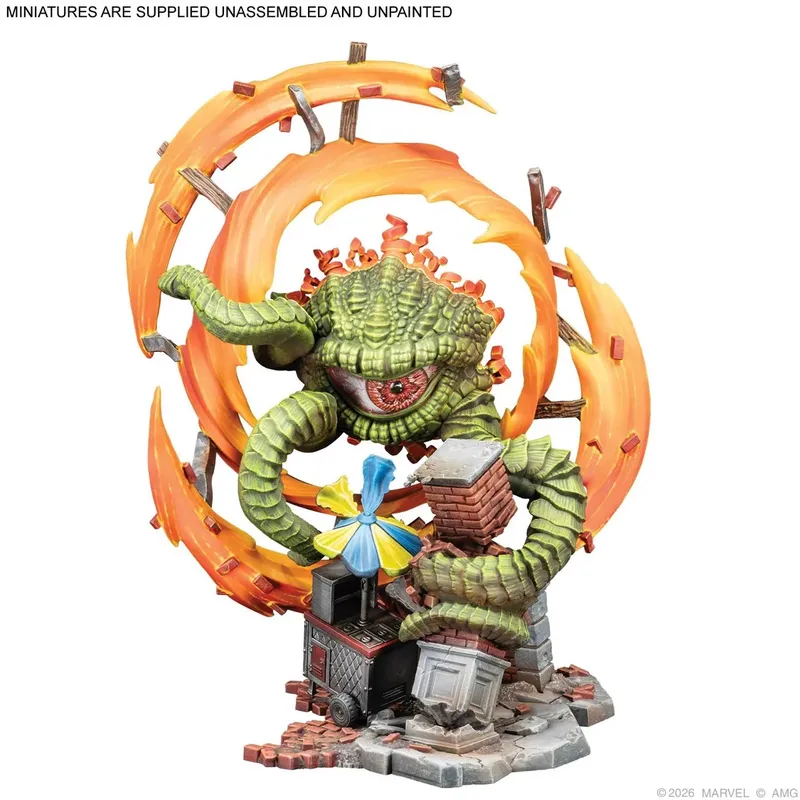 A green, serpentine miniature figure with a large, open mouth and visible teeth, surrounded by a circular arrangement of orange and red flame-like elements with brown wooden debris. The figure is coiled around a small, detailed structure resembling a chimney with a colorful, striped umbrella attached. The base is textured with gray rubble. Text at the top reads: "MINIATURES ARE SUPPLIED UNASSEMBLED AND UNPAINTED". Text at the bottom reads: "©2026 MARVEL © AMG".