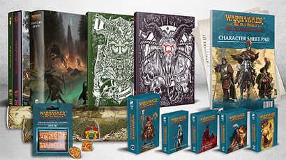 A collection of items from the forthcoming Warhammer: the Old World roleplaying game is displayed prominently. In the background, two large hardback books, the Player's Guide and Gamemaster's Guide, feature intricate cover art, while a character sheet pad is visible to the right. In the foreground, various reference card packs and a set of dice are arranged neatly, showcasing their colorful designs and thematic artwork.