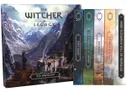 A collection of tabletop game books from "The Witcher: Legacy" series, featuring a prominent cover titled "ASH AND BLOOD" with a scenic illustration of mountains and a castle. Next to it are five additional books, each with distinct colors and titles: "FIRST BLOOD," "FOR A HANDFUL OF COPPERS," "UNFORGUEN," "THE NAME OF DEATH," and a placeholder for "MORE SCENARIOS WILL BE REVEALED." The spines of the books are designed with decorative elements, enhancing their visual appeal.