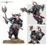 A Black Templars Execrator stands prominently, clad in black power armor adorned with silver details and a white insignia. He wields a master-crafted power sword in one hand and a pyre pistol in the other, with a skull-topped staff featuring angelic wings on his back. The model is set on a grassy base, showcasing intricate details like chains, skulls, and a flowing red cape, emphasizing his role as a devout warrior ready for battle.