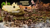 A man with a beard and dark shirt poses beside a detailed miniature fantasy landscape featuring a stone castle, winding hedge maze, rocky terrain, and greenery. Text reads: "CAMPAIGN TRAILER" and "Hagglethorn Hollow Evermaze."