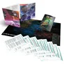Boxed Star Trek Adventures game with open rulebook showing space battle scene, star map, and character sheets. Text reads: "STAR TREK ADVENTURES" and "Second Edition." Includes cards, reference sheets, and a poster.