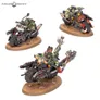 Three green Ork figures riding motorcycles on circular bases.