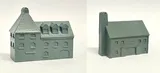 A detailed model of a building designed for 6mm scale wargames, featuring a sloped roof with three dormer windows and a textured surface that resembles slate. The facade includes several arched and rectangular windows, along with a large door at the base, all rendered in a light gray resin. The overall design suggests an industrial style, suitable for various historical or modern warfare settings.