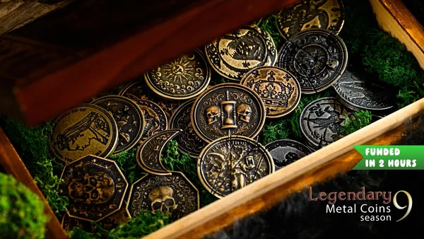A wooden box filled with metal coins featuring intricate designs, including symbols like a crescent moon, crowns, and shields. Green moss-like material lines the box. Overlay text reads: "FUNDED IN 2 HOURS" and "Legendary Metal Coins Season 9."