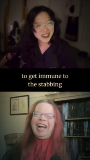 The woman on the top has long, dark hair and is wearing a black top, while the man on the bottom has medium-length, reddish hair and is wearing glasses. Below them, text reads, "to get immune to the stabbing," suggesting a humorous or lighthearted context. In the background, bookshelves filled with various books are visible behind the  man on the bottom.