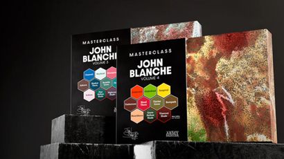 Two sets of John Blanche Masterclass paints are displayed, with Volume 3 on the left featuring a cool color palette, including shades like "Farewell" and "Shadow Thorn," and Volume 4 on the right showcasing warm tones such as "Emberowl" and "Blood Thorn." Both sets are presented in sleek black packaging with vibrant hexagonal labels indicating the paint colors. The background is dark, enhancing the visual impact of the paint sets.
