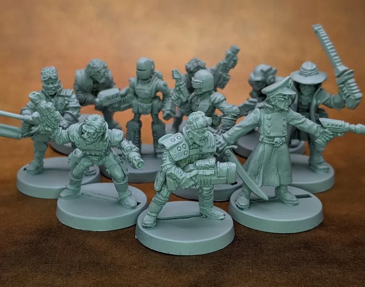 A collection of 28mm scale sci-fi miniatures features various characters, including a Space Commando, a Starchild, an Assault Goar, a Space Orc, and a Voidborn, all sculpted in a retro style reminiscent of the Rogue Trader era. The miniatures are displayed in a group, showcasing their unique designs and details, with some holding weapons and others in dynamic poses. The figures are unpainted and cast in a light gray material, set against a brown background.