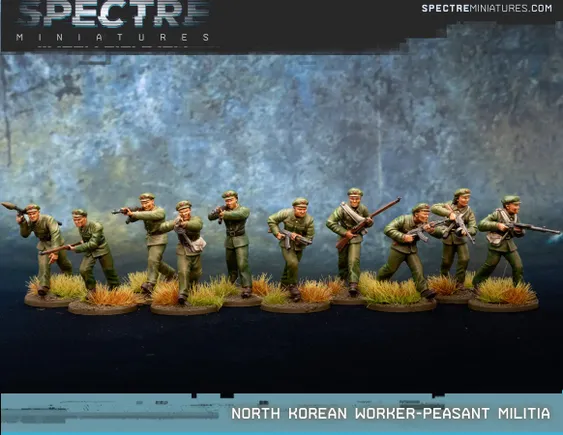 A set of ten miniatures representing North Korean Worker-Peasant Militia figures, each dressed in green military uniforms and equipped with various weapons. The squad includes individuals holding Type 88 rifles, RPK-74s, and some with rifle grenades, all posed in dynamic stances. The base features tufts of grass, enhancing the military aesthetic against a textured blue-gray backdrop.