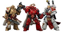 Three action figures representing Blood Angels Space Marines stand side by side. The first figure on the left is clad in red armor, holding a gun, and features intricate detailing. The central figure, also in red, has a prominent golden halo and a cape, while the figure on the right wears white armor with red accents and is equipped with various accessories, including a holstered weapon and a mechanical arm.