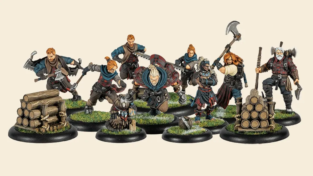 A group of eight intricately designed miniatures representing the Lumberjacks team from Steamforged Games is displayed. The figures are depicted in dynamic poses, showcasing a variety of weapons and tools, including an axe and a saw, with detailed clothing that features earthy tones and patterns. In the foreground, a small log pile is included, enhancing the thematic elements of the team, which emphasizes their connection to woodworking and the outdoors.