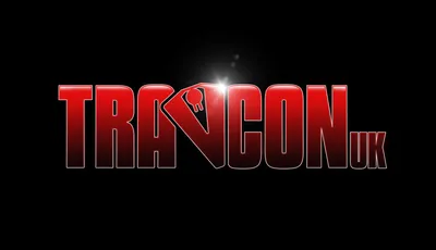 The image features the logo for "Travcon," prominently displayed in bold, red letters against a black background. The "TRA" portion of the logo is stylized, with a key symbol integrated into the letter "V," adding a unique touch. The overall design conveys a sense of excitement and adventure, fitting for a convention dedicated to the Science Fiction RPG game, Traveller.