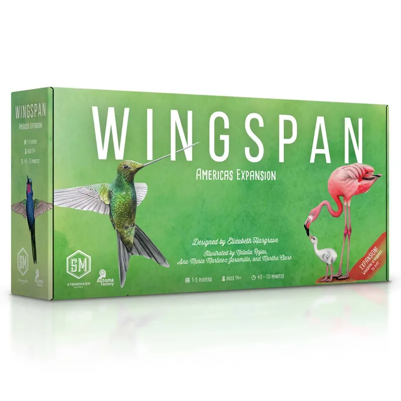 A box for the "Wingspan: Americas Expansion" features a vibrant green background with illustrations of various birds, including a colorful hummingbird on the left and a pink flamingo on the right. The title "WINGS PAN" is prominently displayed in large white letters, with the subtitle "Americas Expansion" below it. Additional text notes the game's design and illustration credits, along with details about player count and age suitability.